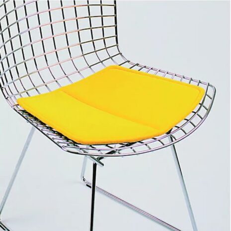 bertoia chairs with yellow pillow