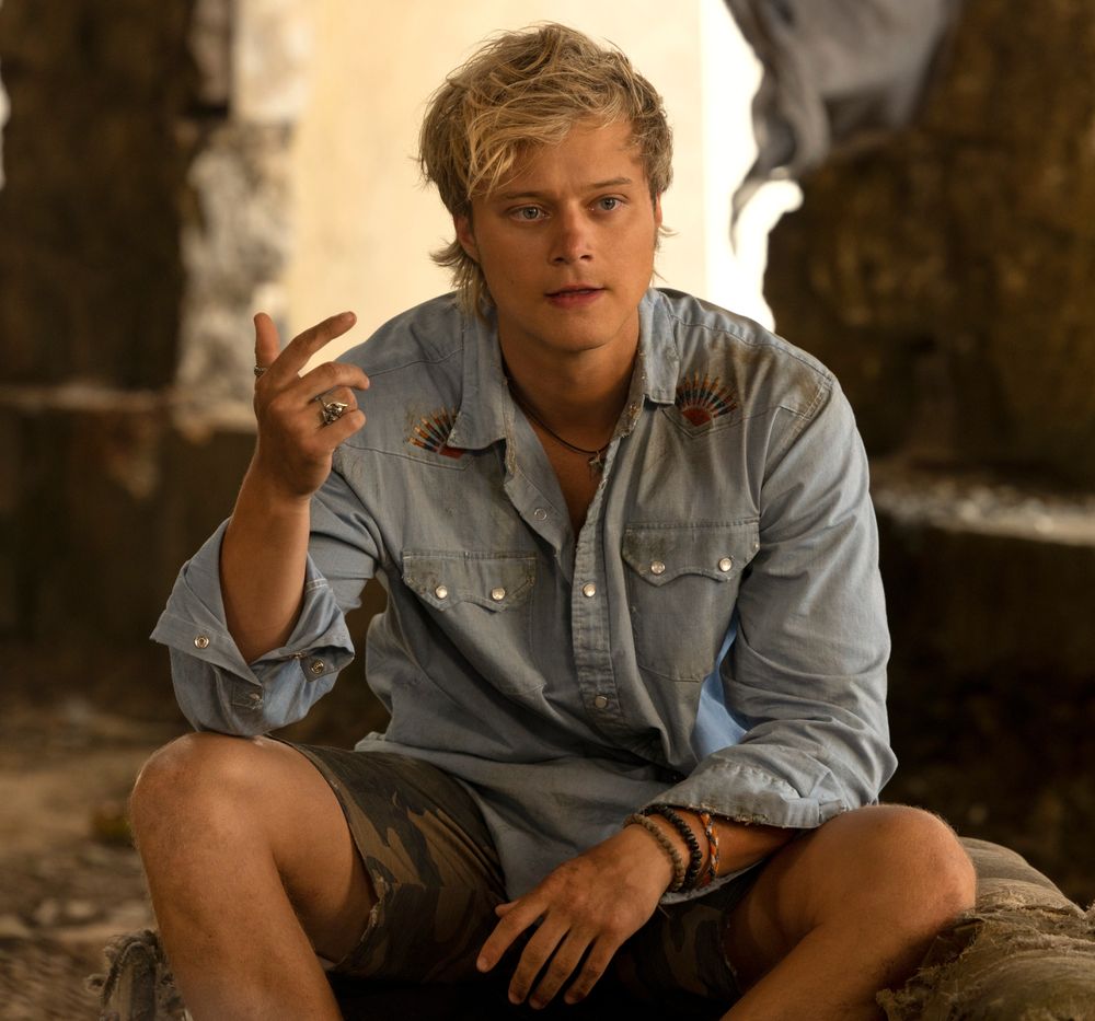 JJ Maybank denim shirt and camo cargo shorts look Outer Banks
