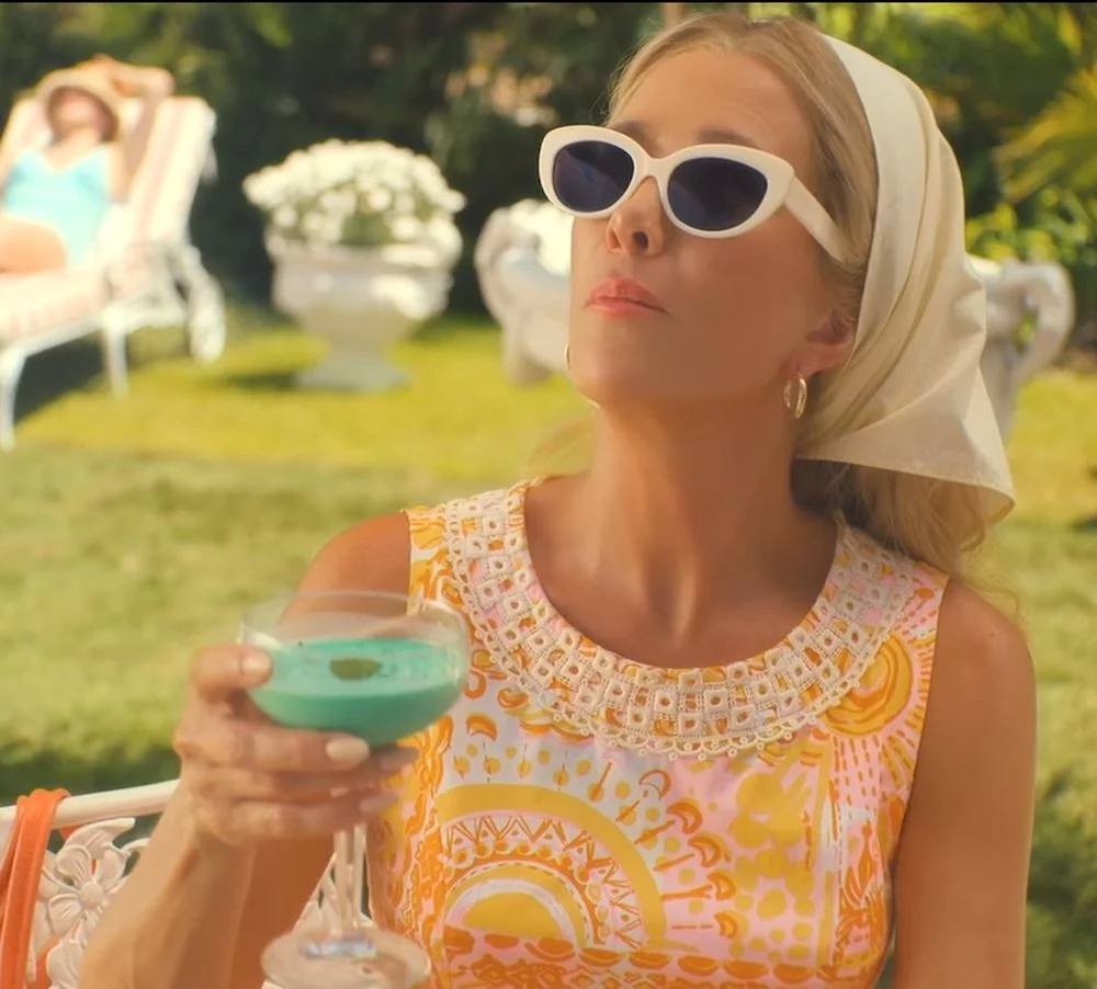 palm royale orange dress Vintage Inspired Orange and White Sleeveless Dress of Kristen Wiig as Maxine Simmons in Palm Royale TV Show